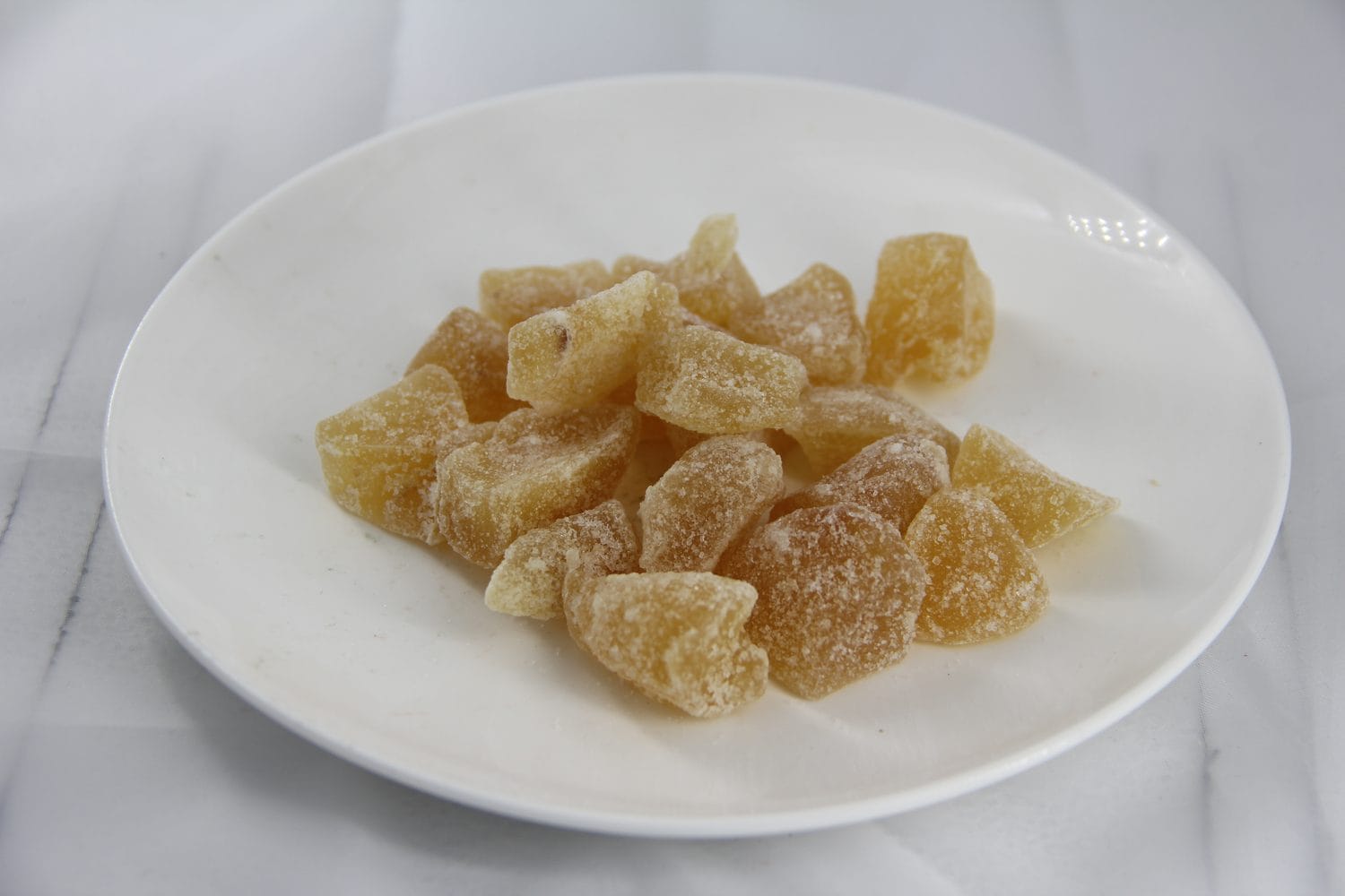 Close view of sugar-coated crystallized ginger pieces