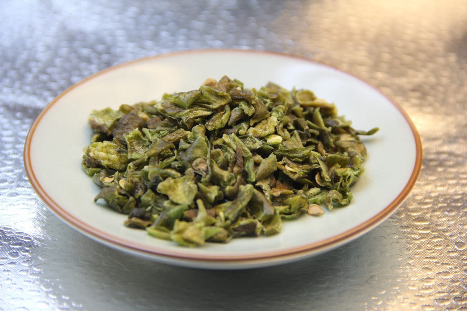 Close view of dehydrated green bell pepper flakes