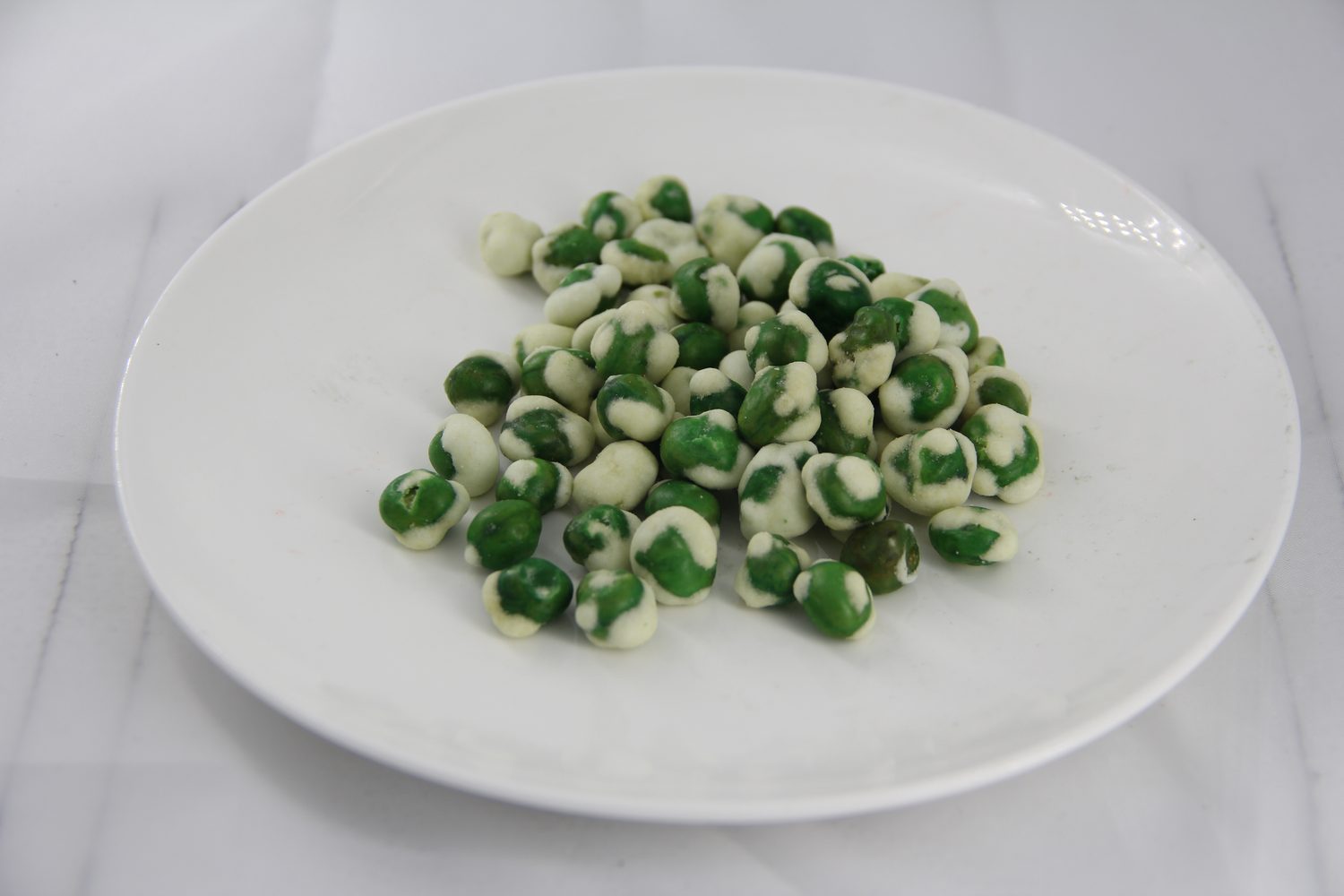 Close view of white wasabi coated green peas